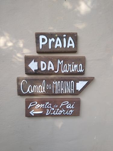 a group of street signs on a wall at Morada do Sol Guest House in Búzios