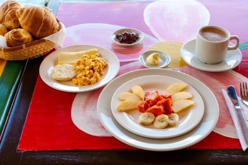 a table with two plates of food and a cup of coffee at Villa Patty in Tibasosa