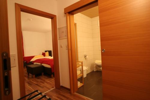 a bedroom with a bed and a mirror at Hotel Engl in Innsbruck