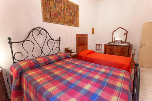 a bedroom with two beds and a mirror at Ca' Lilli in Cantiano