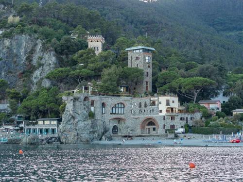 a large building on a hill next to the water at La Casa del Gigante Luxury Collection in Monterosso al Mare