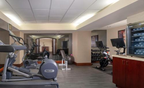 a gym with cardio equipment in a hotel room at The Ashton Hotel in Fort Worth