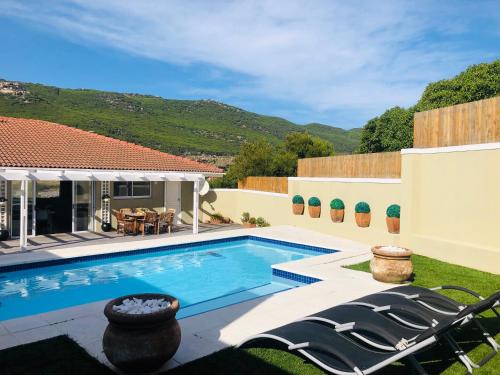 a swimming pool in the backyard of a house at Whale Bay Villa in Fish Hoek