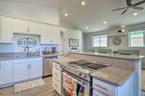 a kitchen with white cabinets and a stove top oven at Hurricane Getaway with Yard - 25 Mi to Zion! in Hurricane