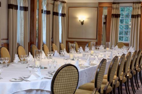 a conference room with a long table and chairs at Manor Hotel Solihull, BW Signature Collection in Bickenhill