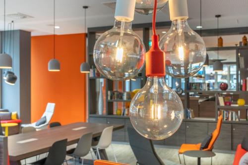 a group of wine glasses hanging in a restaurant at Campanile Frankfurt Offenbach in Offenbach