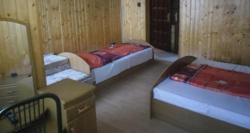 A bed or beds in a room at Dudás panzió