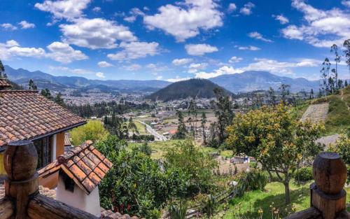a view of the mountains from a house at INTIYAYA - Boutique Lodge in Otavalo