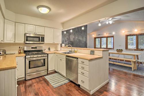 a kitchen with white cabinets and stainless steel appliances at Family Escape - Near Little Traverse Wheelway in Harbor Springs