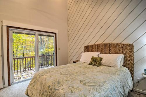 a bedroom with a bed and a large window at Family Escape - Near Little Traverse Wheelway in Harbor Springs