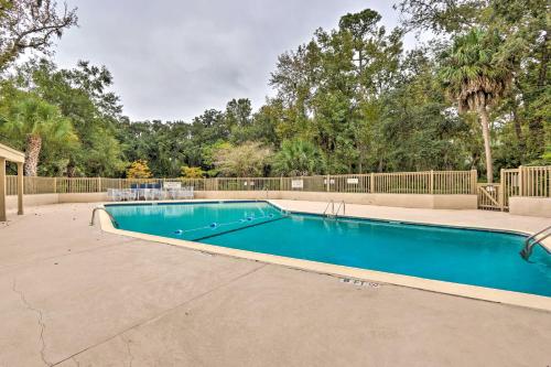 a swimming pool in a yard with trees at Golf Course Views and Beach Access Shipyard Villa in Hilton Head Island