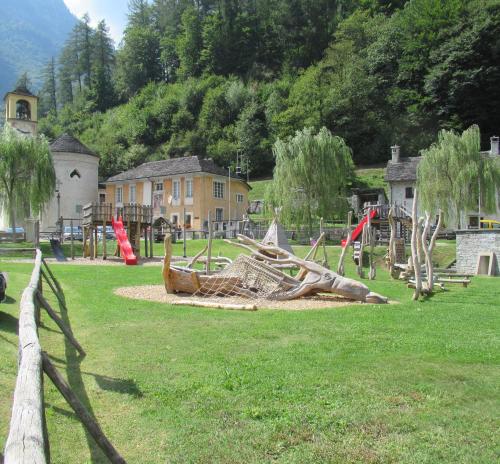 a playground with a bunch of playground equipment in a field at Casa Marco in Brione