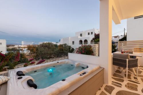 a hot tub on the balcony of a house at Kandiani Bleu Ciel in Naousa