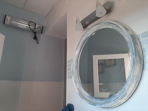 a bathroom with a mirror and a hair dryer at Casa rural "Garnacha de Borja" guest home in Borja