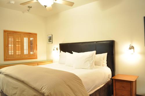 a bedroom with a large bed with a black headboard at Juniper Springs Lodge # 203 in Mammoth Lakes