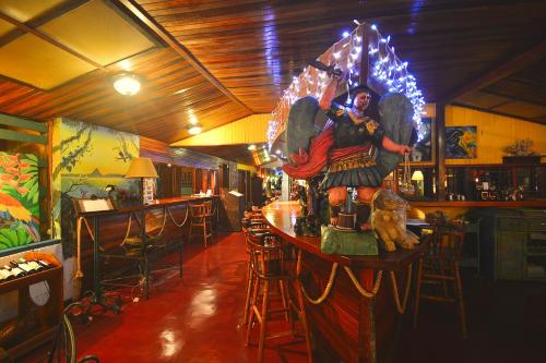 a bar with a statue of an angel on the counter at Hotel La Mansion Inn Arenal in Nuevo Arenal
