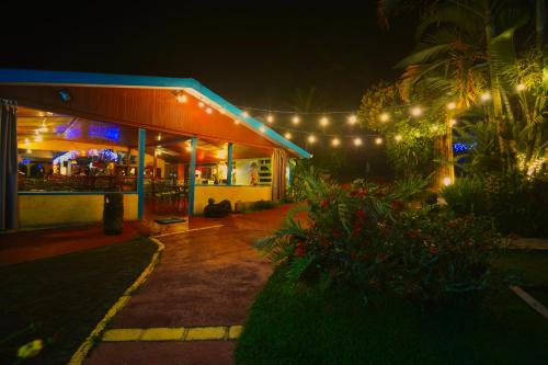 a building with christmas lights on it at night at Hotel La Mansion Inn Arenal in Nuevo Arenal