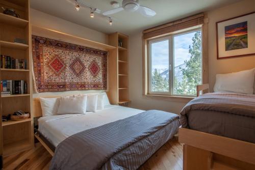 a bedroom with two beds and a window at Juniper Springs Lodge # 426 in Mammoth Lakes
