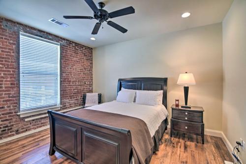 a bedroom with a bed and a brick wall at Historic Condo in Downtown, Walk to Riverfront! in Vicksburg