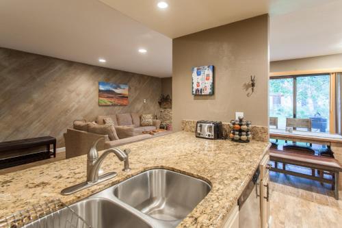 a kitchen with a sink and a living room at Snowcreek #405 - Phase III in Mammoth Lakes