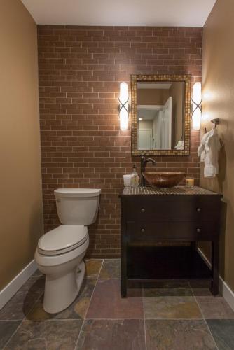 a bathroom with a toilet and a sink and a mirror at Snowcreek #754 - Phase V in Mammoth Lakes