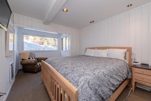 a bedroom with a bed and a window at Chamonix # 62 in Mammoth Lakes