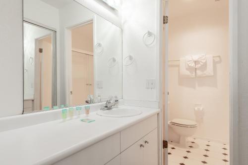a white bathroom with a sink and a toilet at Chamonix # 62 in Mammoth Lakes