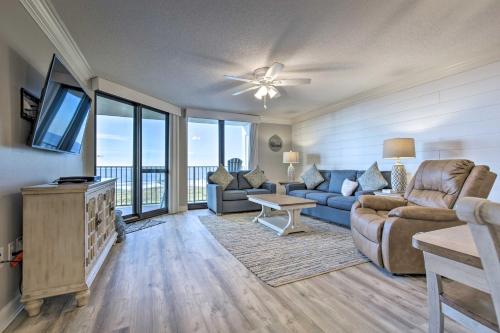 a living room with a couch and a tv at Coastal Orange Beach Condo Resort and Beach Access! in Orange Beach