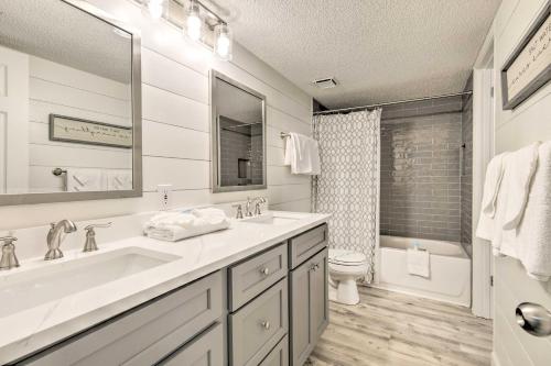 a white bathroom with a sink and a toilet at Coastal Orange Beach Condo Resort and Beach Access! in Orange Beach