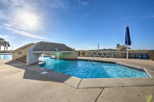 a swimming pool with a slide in a building at Coastal Orange Beach Condo Resort and Beach Access! in Orange Beach