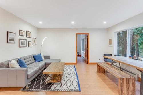 a living room with a couch and a table at McKinnis Hill Cabin in Eastsound