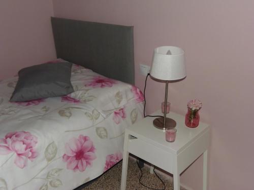 a bedroom with a bed and a table with a lamp at Casa rural "Garnacha de Borja" guest home in Borja
