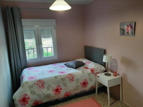 a small bedroom with a bed and a window at Casa rural "Garnacha de Borja" guest home in Borja