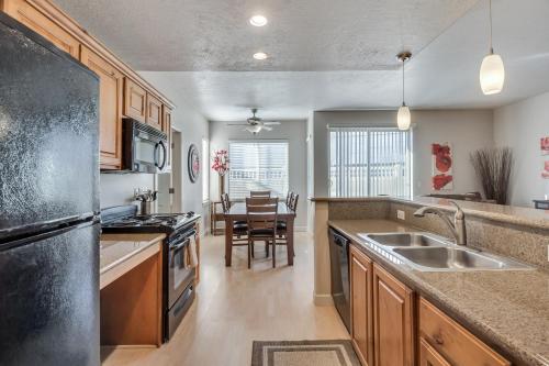 a kitchen with a sink and a stove at Downtown Condo Near Convention Center (Disability Access) in Salt Lake City