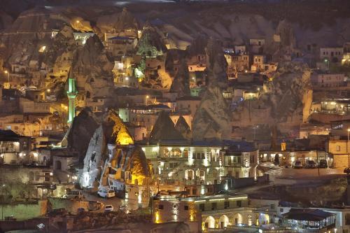 a city lit up at night on a mountain at Harman Cave Hotel in Goreme