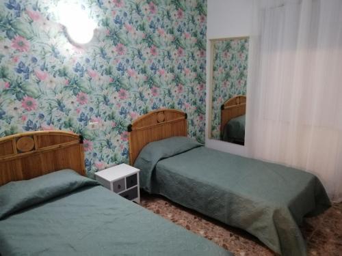 A bed or beds in a room at Alcaravaneras Hostel