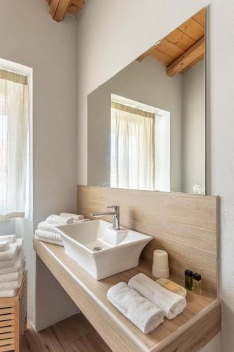 a bathroom with a sink and a mirror at La Posteria by iCasamia it in Orino