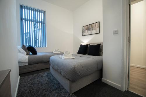 a bedroom with a bed and a couch and a window at Corpa Retreat in Newport