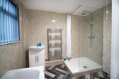 a bathroom with a shower and a toilet and a sink at Corpa Retreat in Newport