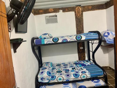a bunk bed with blue and white plates on it at Cabaña hotel conde in Doradal