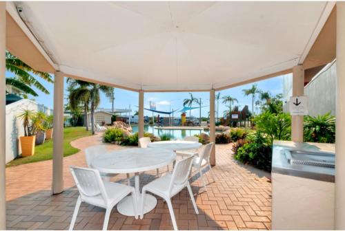 a patio with a table and chairs on a brick patio at Discovery Parks - Townsville in Townsville