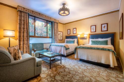 a hotel room with two beds and a couch at The Ahwahnee in Yosemite Village