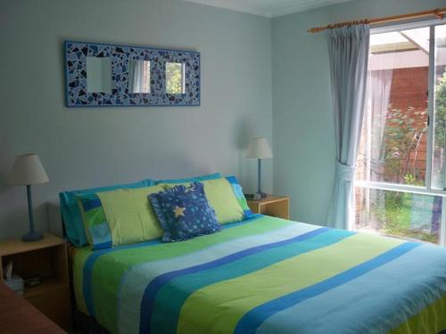 En eller flere senge i et værelse på Blairgowrie Relaxation