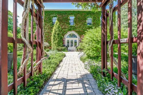 a brick building with a pathway leading to a door at School House Bed and Breakfast C.1859 in Niagara on the Lake