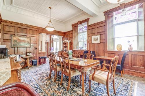 a dining room with wooden walls and a table and chairs at School House Bed and Breakfast C.1859 in Niagara on the Lake