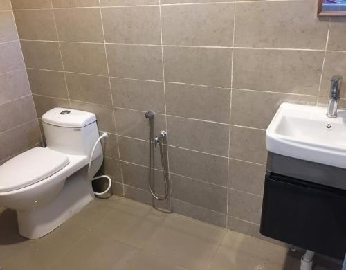 a bathroom with a toilet and a sink at CASA ADELIA STUDIO CHUKAI in Cukai