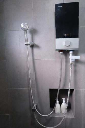 a shower in a bathroom with a shower head at Li CALLA Resort Trat in Trat
