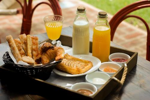 a tray of food with pastries and drinks on a table at Refugio En Las Sierras in Tandil
