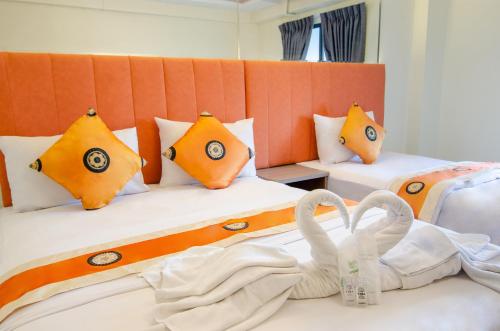 two beds in a room with towels on the beds at Tara Lake in Bangkok