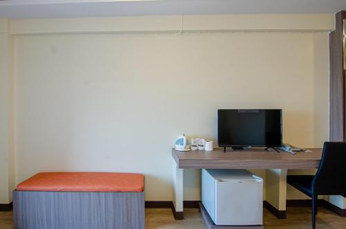an office with a desk with a monitor and a stool at Tara Lake in Bangkok